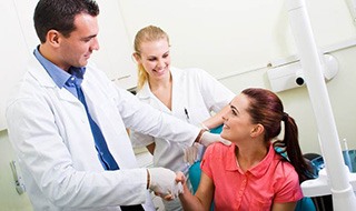Emergency dentist in Burlington shaking hands with a patient
