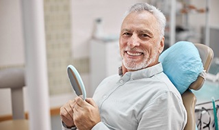 senior man at a consultation for dental implants in Burlington 