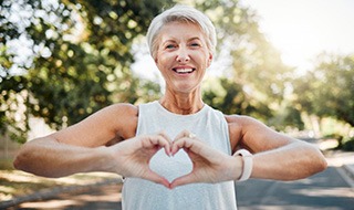 Lady makes shape of heart with her hands
