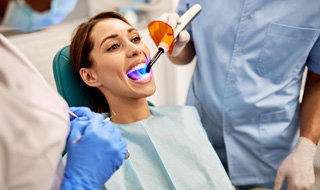 Woman’s dental bonding hardened with UV light