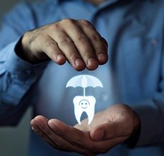 Hands holding an animated tooth under an umbrella