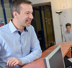 Smiling man at reception desk in dental office