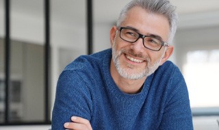 closeup of man smiling with arms crossed