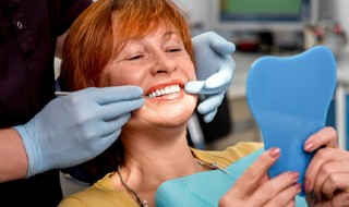 woman smiling while visiting dentist