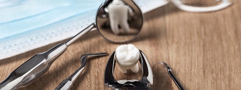 an extracted tooth on a table with dental tools