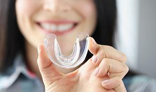 closeup of woman holding a mouthguard