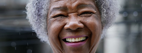 Woman smiling brightly with snow in the background
