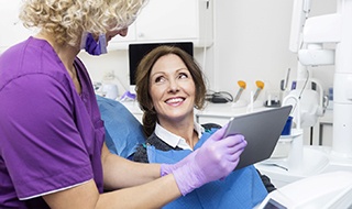 dental implant dentist in Burlington showing a patient their X-rays 
