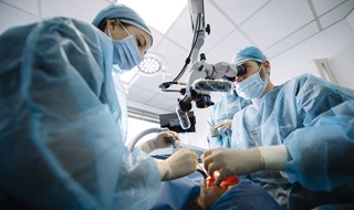 A dentist and their team perform dental implant surgery on a patient in Burlington