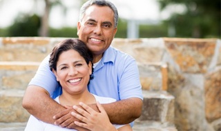 An older couple hugging.