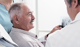 Smiling older man in dental chair