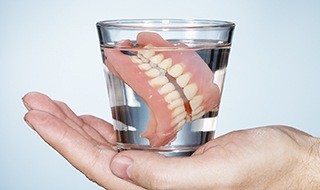 Full dentures in glass of water
