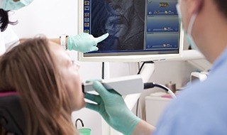 Dentist and patient looking at intraoral photos