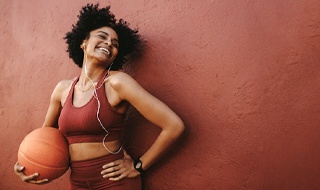 person holding basketball and smiling