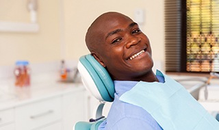 Male patient smiling after getting veneers in Burlington, MA