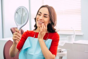 woman looking pleased with dental work