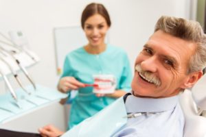 Smiling older man happy with his new dental implants