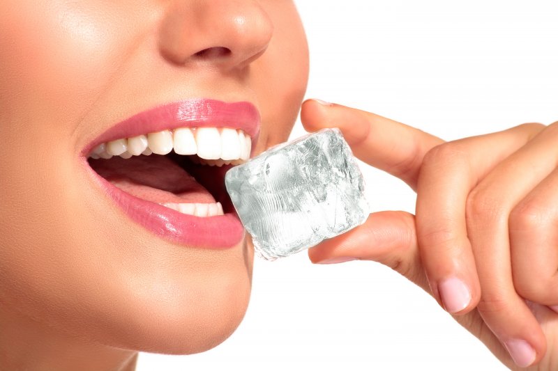 woman chewing on ice cube