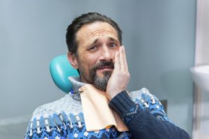 pained man visiting his Burlington emergency dentist