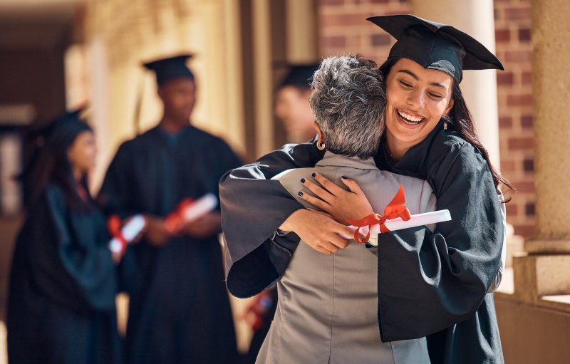 A graduating student hugging a loved one