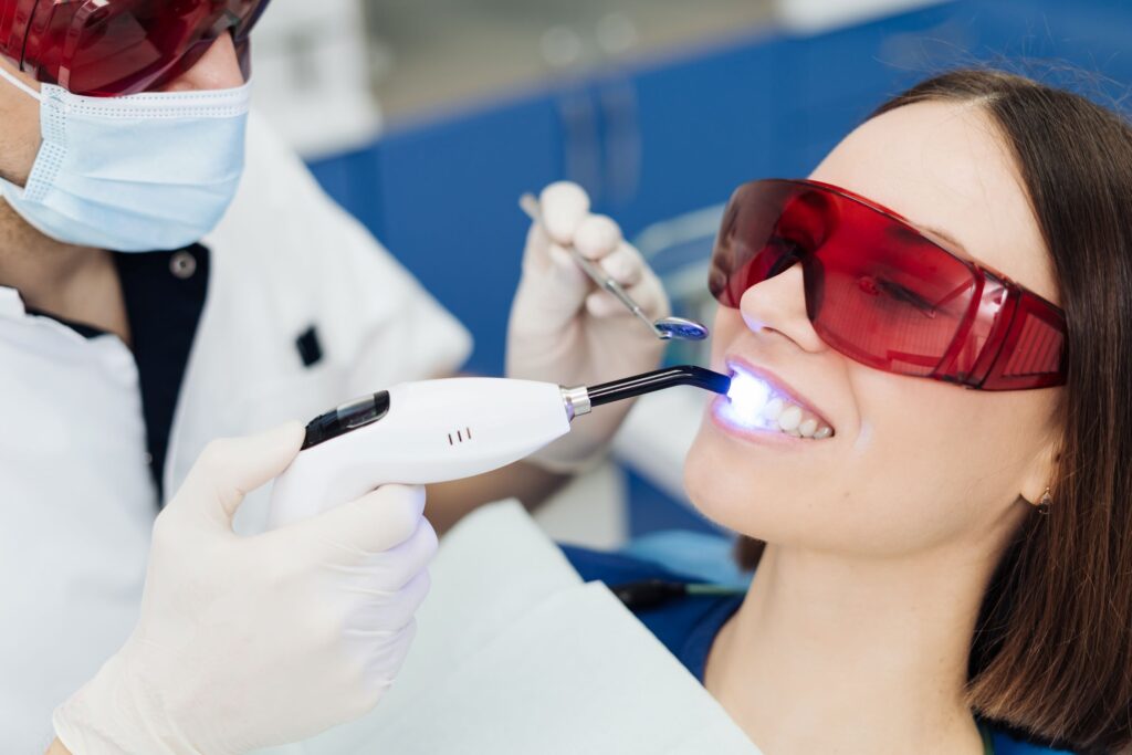 Woman in dental chair having teeth professionally whitened